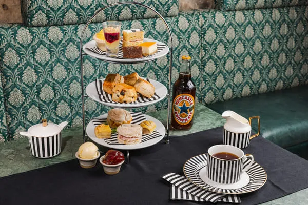afternoon tea with scones, cakes and coffee on table